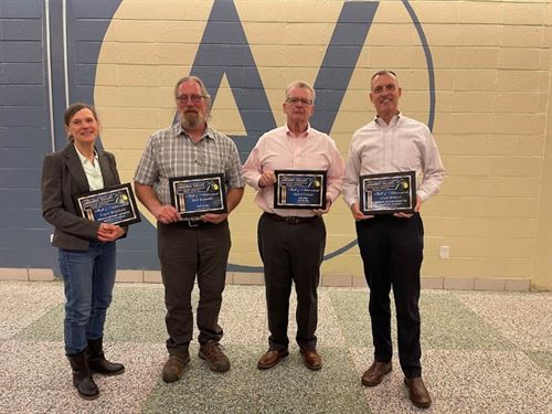 Hall of Achievement winners pose in a group with their plaques